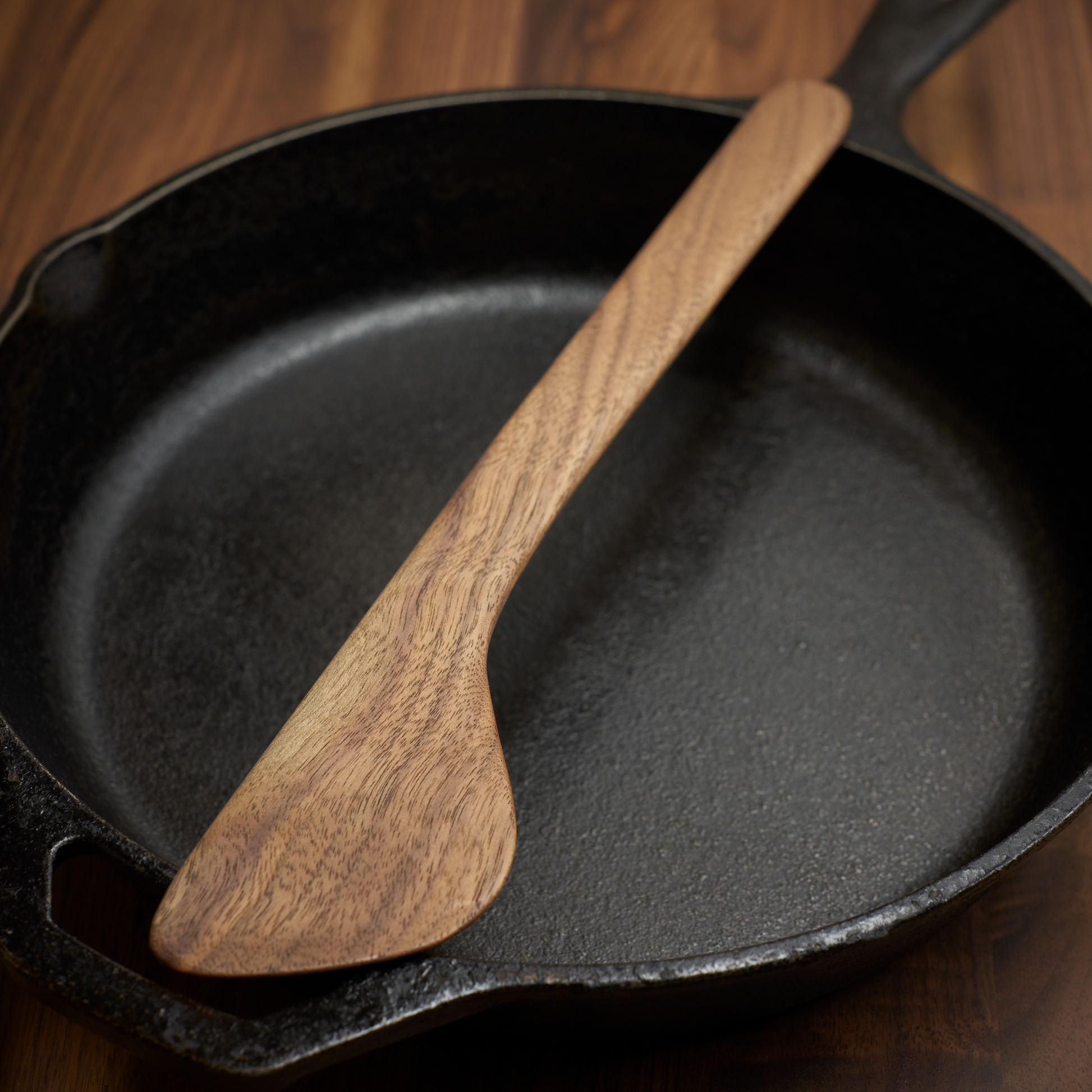 Handmade Walnut Cooking Spatula on Cast Iron Pan