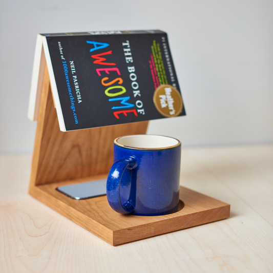 A wooden book caddy rest your favourite book, beverage, and phone, made out of beautiful cherry hardwood.