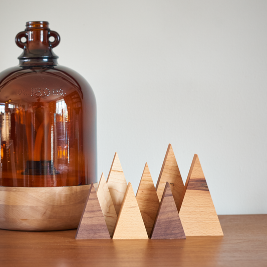 collection of tree family decorations in different sizes and wood types