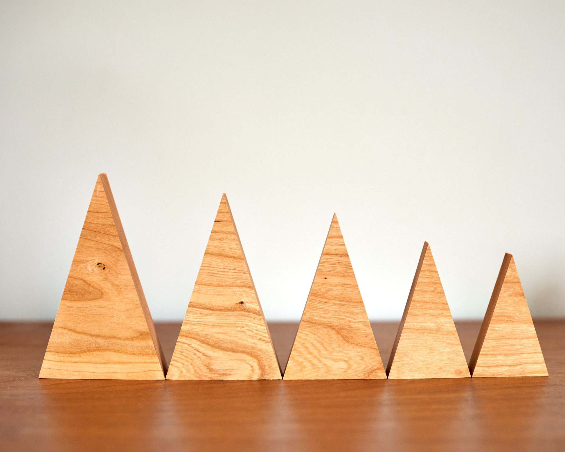 collection of tree family decorations in available sizes in Solid Cherry