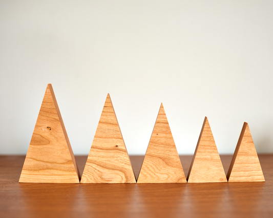 collection of tree family decorations in available sizes in Solid Cherry