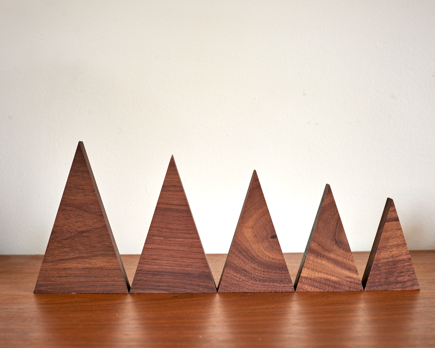collection of tree family decorations in available sizes in Solid Walnut